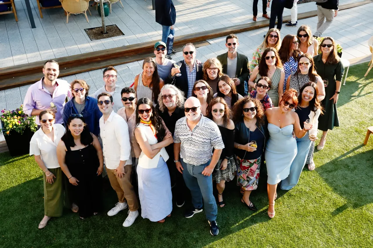 The Proscenium team and clients gathered on a rooftop terrace